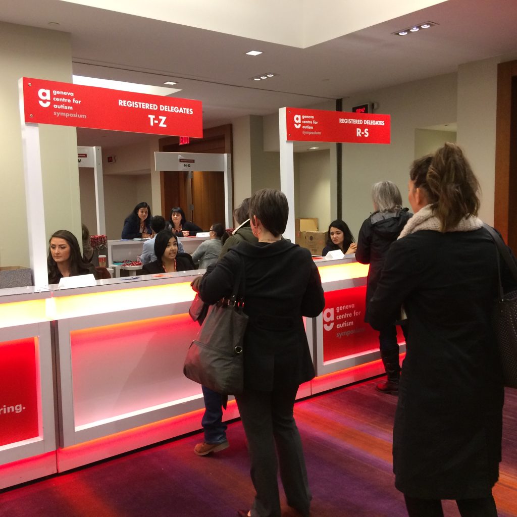 Attendees lining up for registration at a conference.